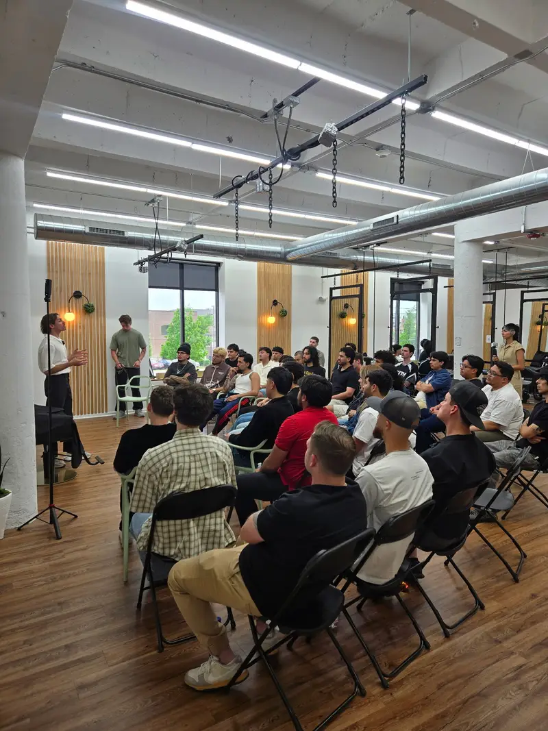 Speaker addressing a room of seated barbers